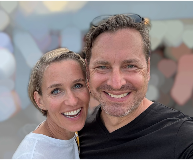 Die Paartherapie Köln Ein lächelndes Paar steht nah beieinander, mit verschwommenem Hintergrund.